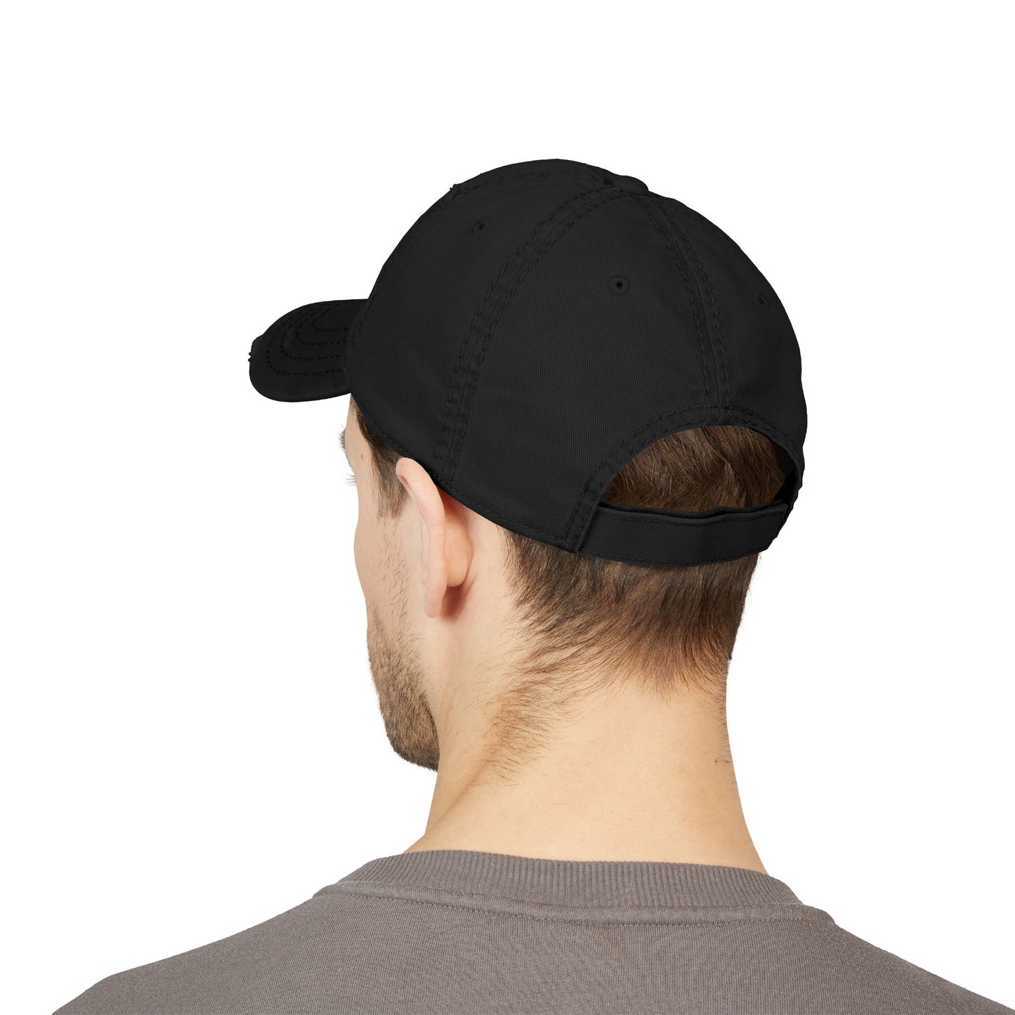 Black cap worn by a person on a white background