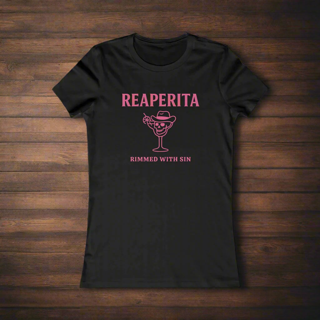 Black t-shirt with 'Reaperita Rimed with Sin' design on a wooden surface with limes and ice cubes.