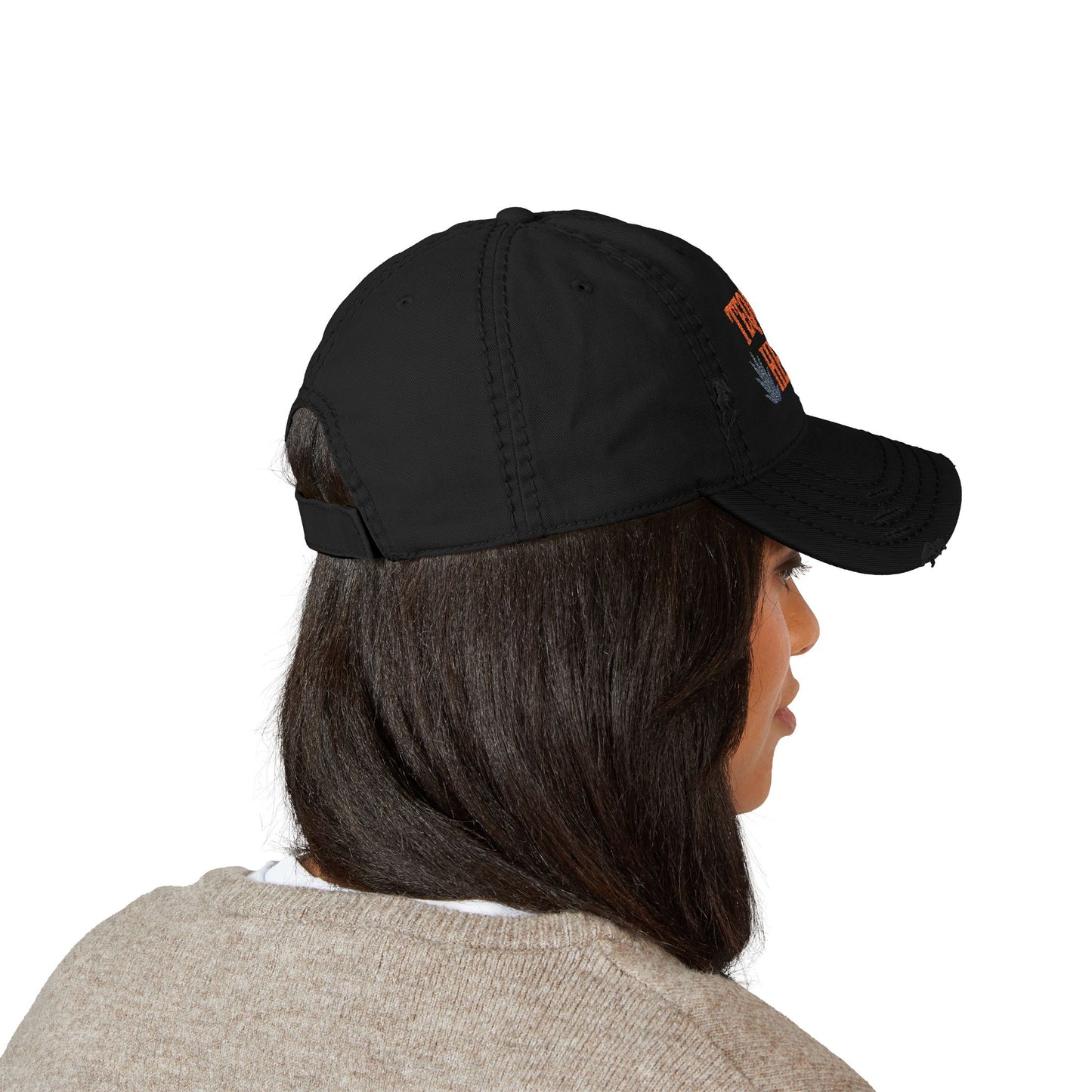 Person wearing a black cap with a logo on a white background