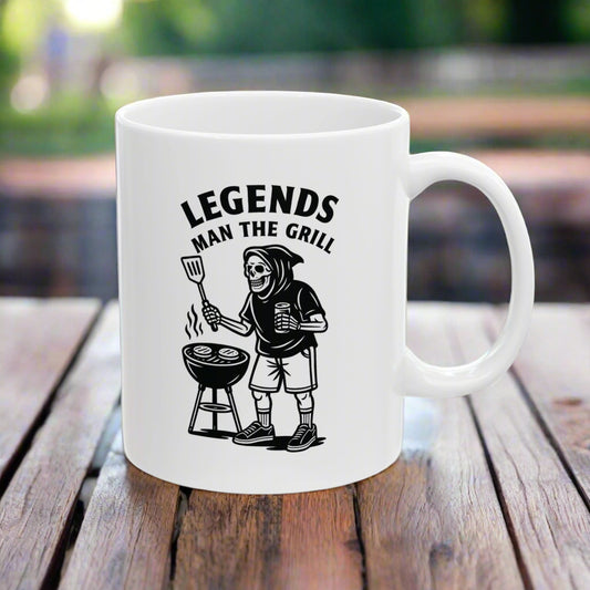 White mug with black graphic and text 'Legends Man The Grill' on a white background