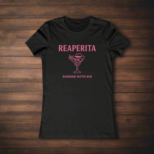 Black t-shirt with 'Reaperita Rimed with Sin' design on a wooden surface with limes and ice cubes.