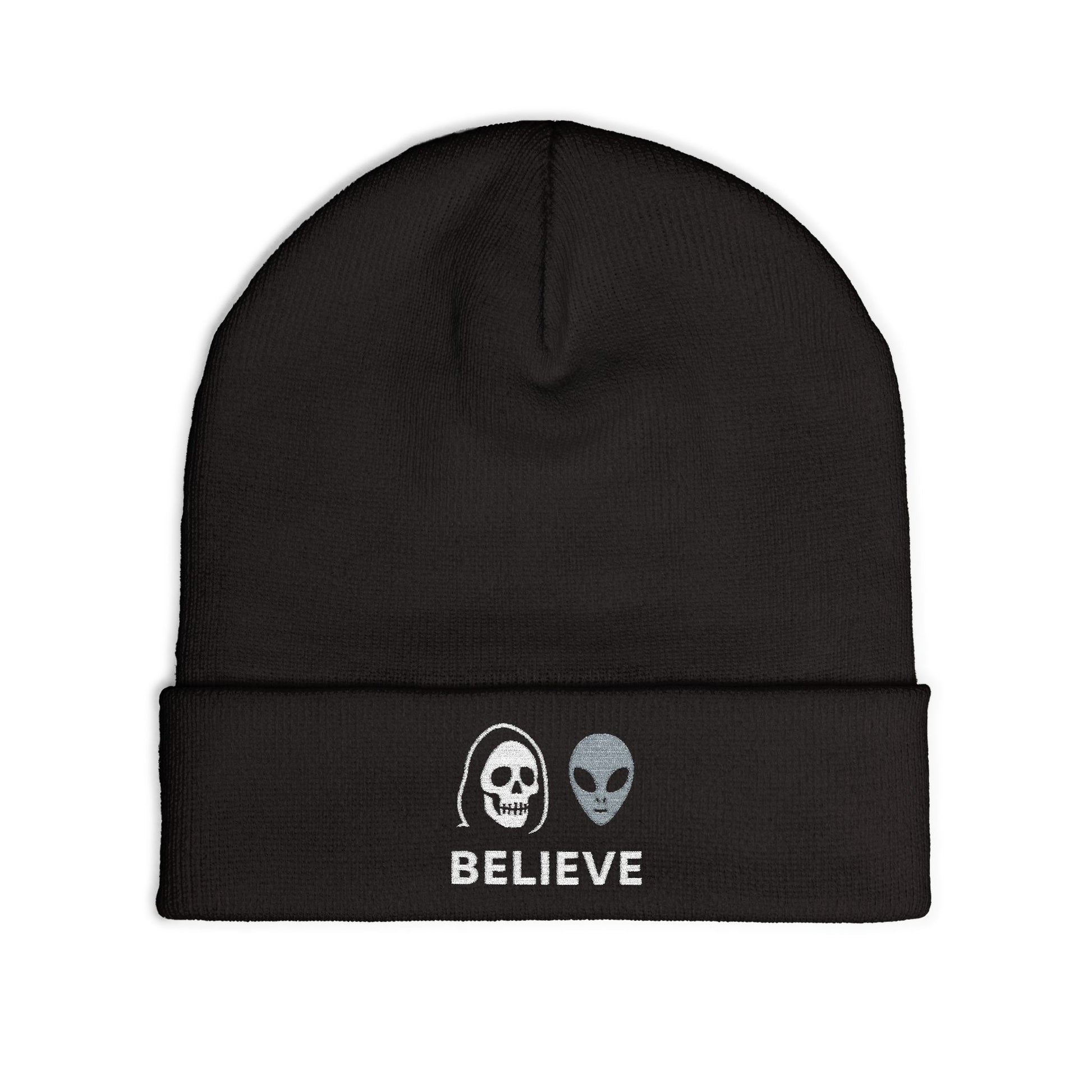 Black beanie with alien and skull design and 'BELIEVE' text on a white background
