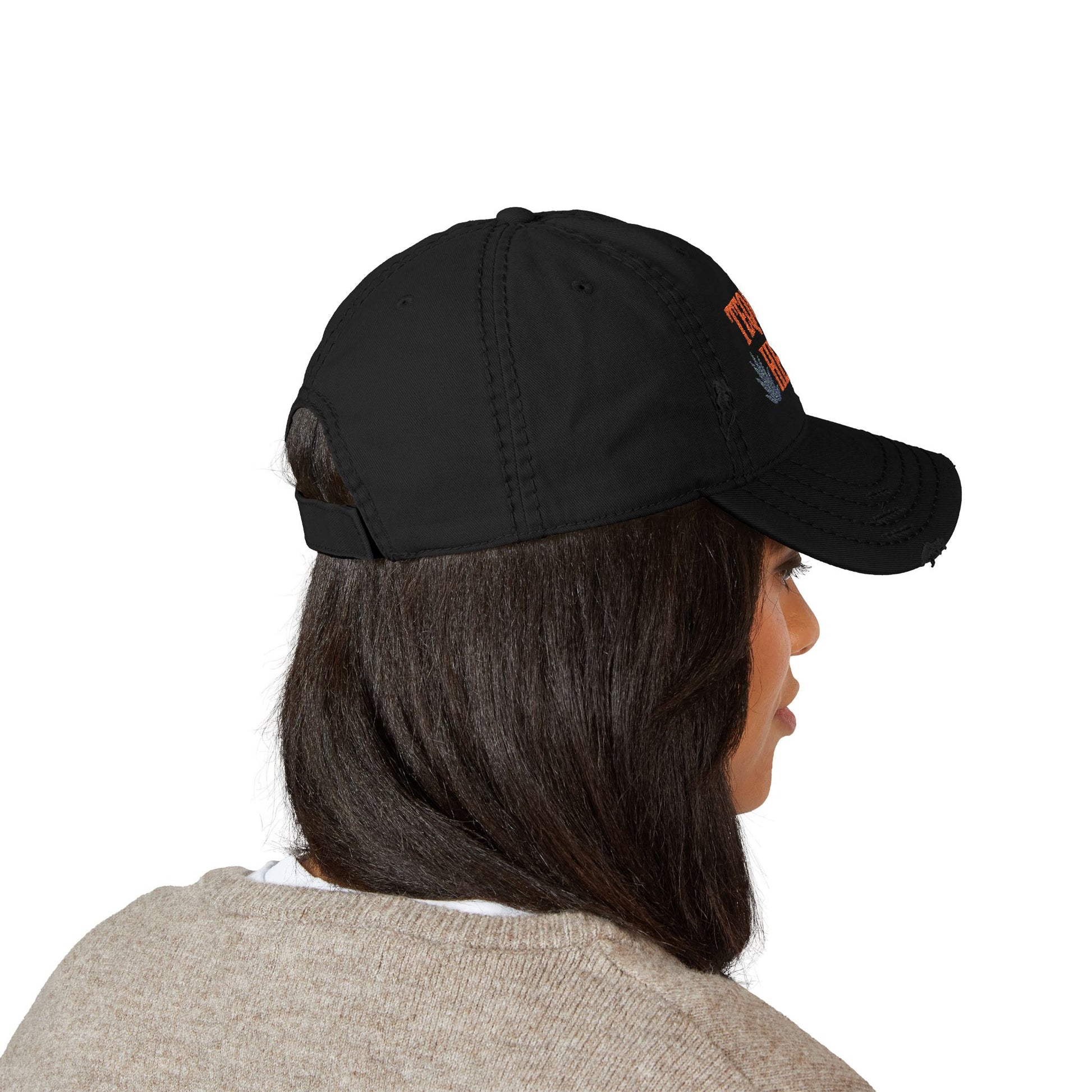 Person wearing a black cap with a logo on a white background