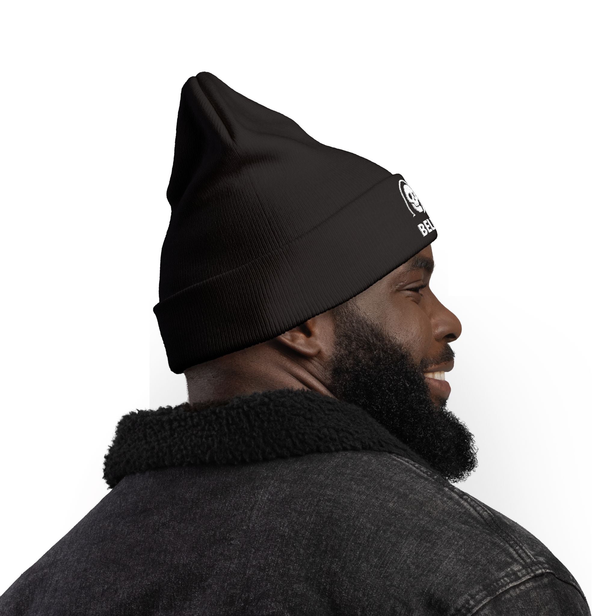 Man wearing a black beanie with a logo on a white background